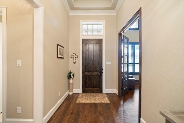 entryway featuring dark wood finished floors, baseboards, and ornamental molding