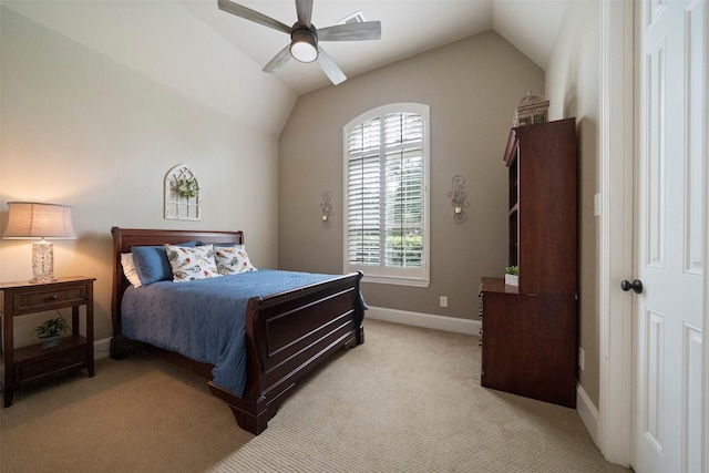 bedroom with ceiling fan, vaulted ceiling, baseboards, and light carpet