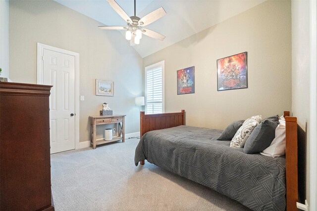 bedroom featuring vaulted ceiling, light colored carpet, baseboards, and ceiling fan