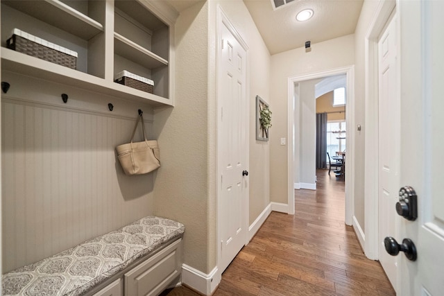 mudroom with visible vents, baseboards, and wood finished floors