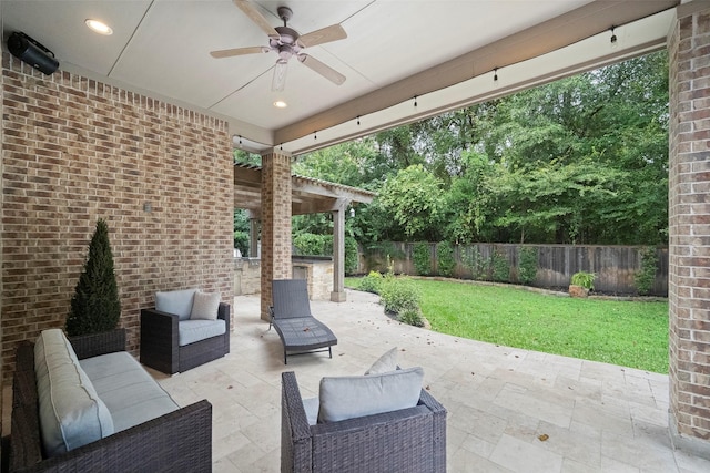 view of patio / terrace featuring an outdoor hangout area, a fenced backyard, and ceiling fan