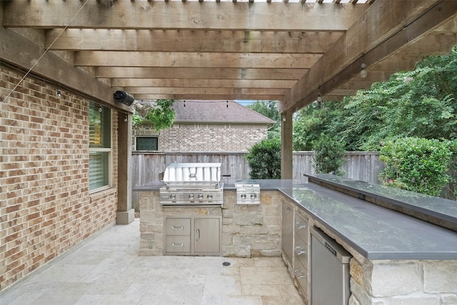 view of patio with area for grilling, fence, a pergola, and grilling area