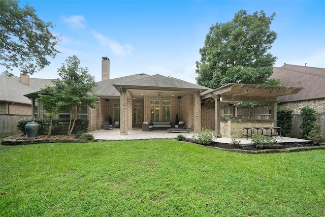 back of house featuring fence, a pergola, ceiling fan, a patio area, and a lawn