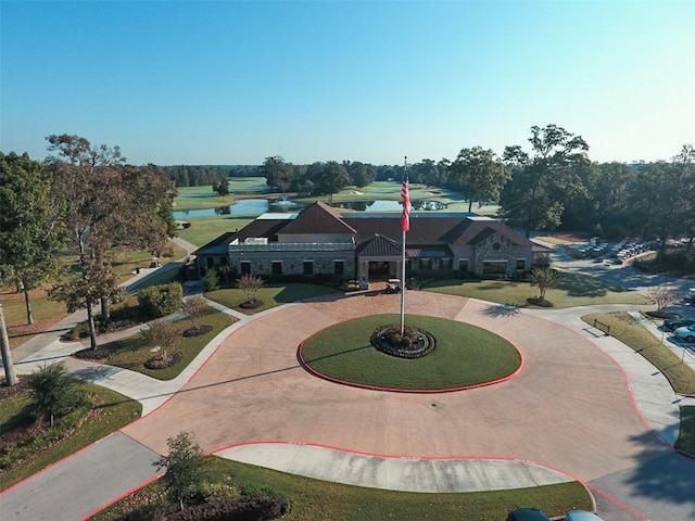 view of front facade with a water view and curved driveway