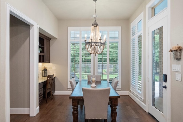 dining space featuring visible vents, baseboards, dark wood-type flooring, and a chandelier