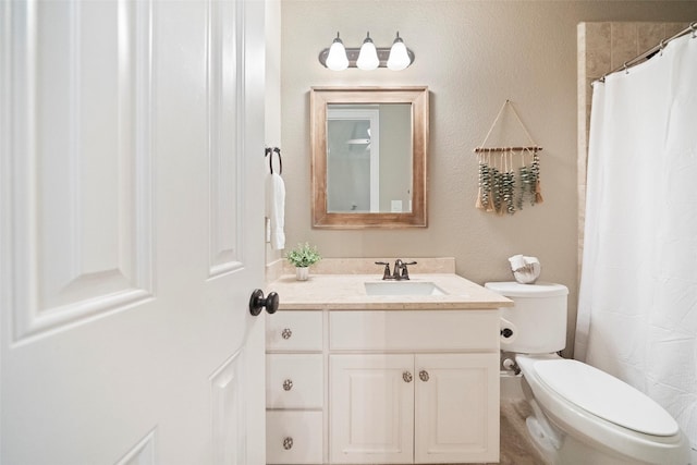 bathroom featuring vanity, toilet, and a shower with curtain