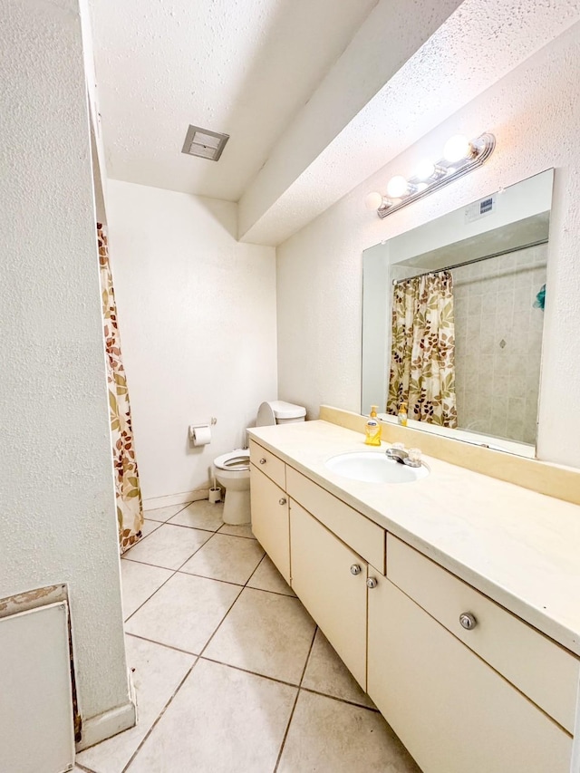 bathroom with visible vents, toilet, tile patterned flooring, a textured ceiling, and vanity