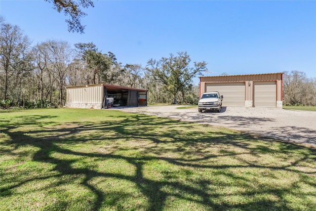 garage featuring a garage and gravel driveway