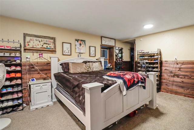 bedroom with light carpet and wainscoting