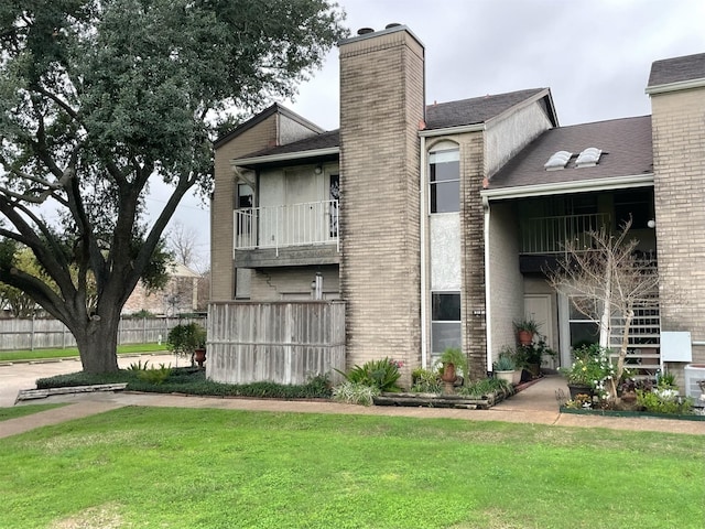 view of property with stairway and fence