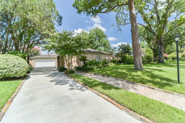 view of front facade featuring a front yard and a gate