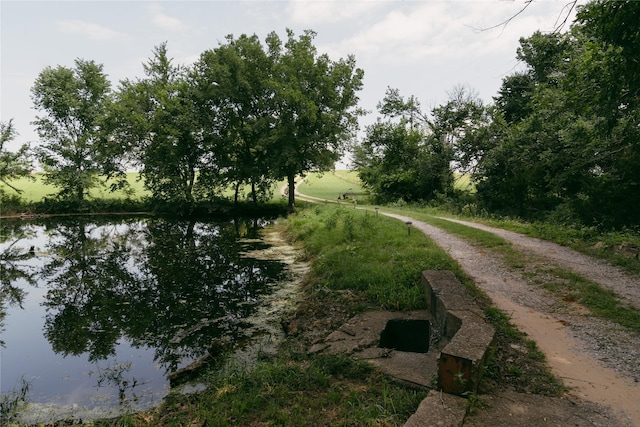 exterior space with driveway and a water view