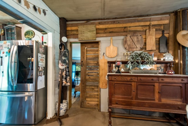 kitchen with concrete flooring, smart refrigerator, and brown cabinets