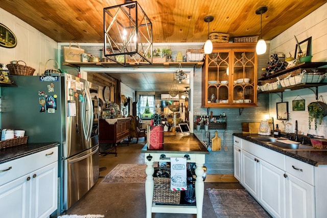 kitchen with open shelves, dark countertops, a sink, wooden ceiling, and stainless steel fridge with ice dispenser