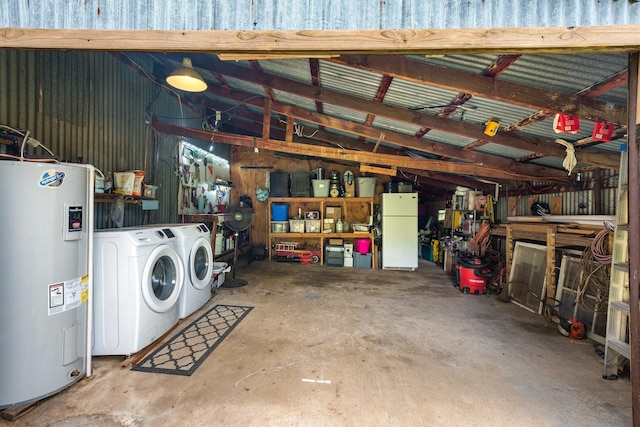 garage featuring independent washer and dryer, freestanding refrigerator, metal wall, and electric water heater