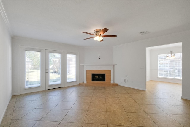 unfurnished living room with a wealth of natural light, visible vents, and crown molding