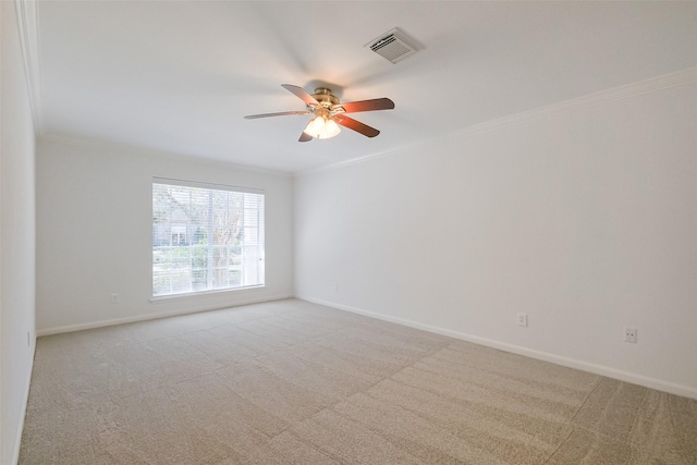 unfurnished room with light carpet, visible vents, baseboards, and ornamental molding