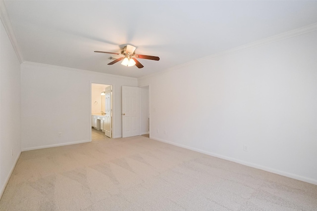 empty room with ceiling fan, light colored carpet, baseboards, and ornamental molding