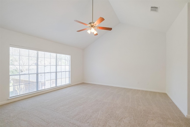 spare room with baseboards, visible vents, high vaulted ceiling, ceiling fan, and light carpet