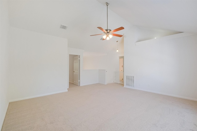 spare room with visible vents, light carpet, high vaulted ceiling, and a ceiling fan