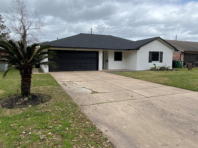 ranch-style house with brick siding, a shingled roof, an attached garage, driveway, and a front lawn