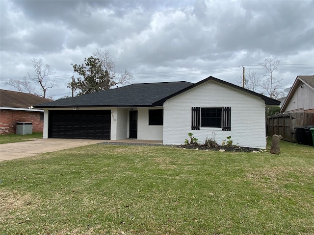 ranch-style house with concrete driveway, an attached garage, fence, a front lawn, and brick siding