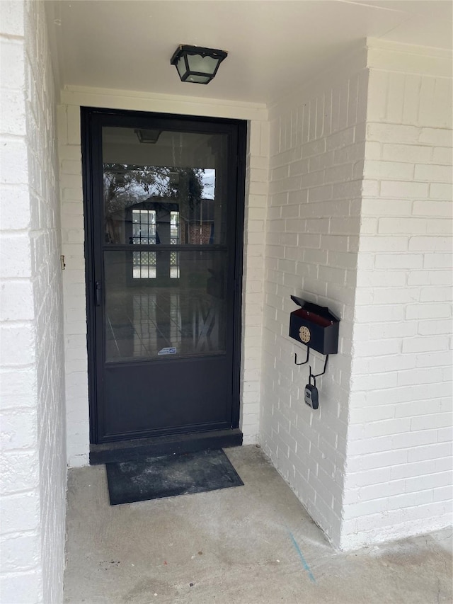 property entrance with brick siding