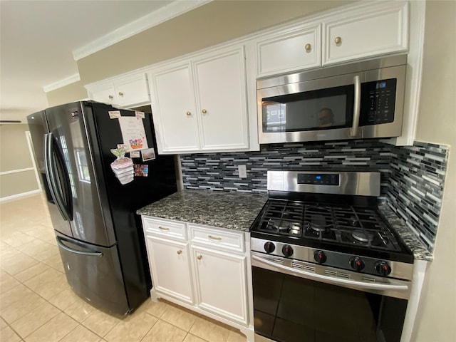 kitchen featuring appliances with stainless steel finishes, white cabinets, crown molding, and tasteful backsplash