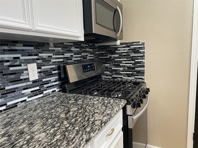 kitchen featuring white cabinetry, appliances with stainless steel finishes, and backsplash