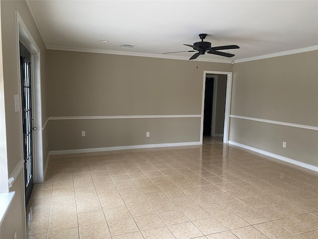 spare room with visible vents, crown molding, baseboards, and ceiling fan