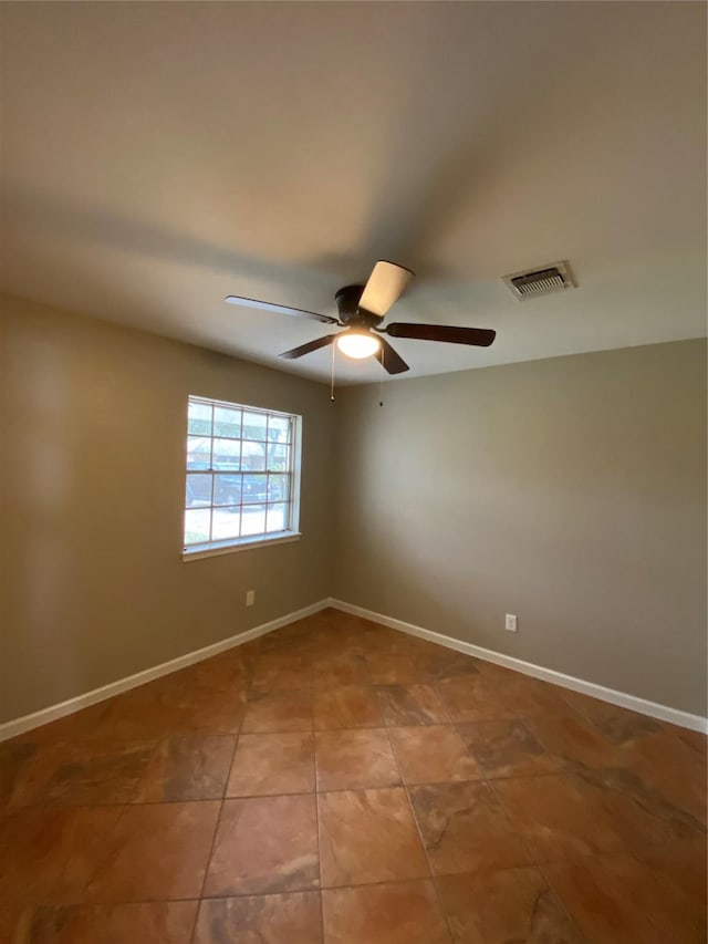 unfurnished room featuring baseboards, visible vents, a ceiling fan, and tile patterned floors