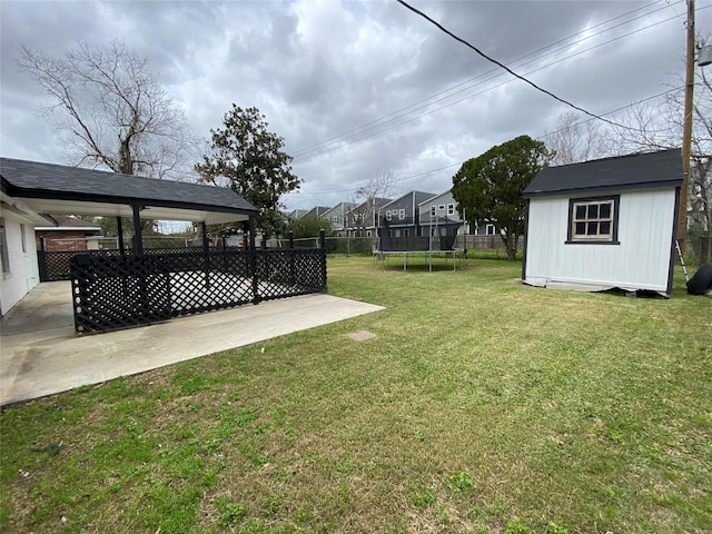 view of yard featuring a patio, a fenced backyard, an outbuilding, a trampoline, and a shed