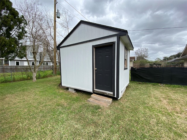 view of shed featuring fence