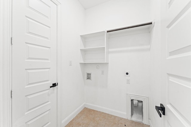 laundry area with hookup for a washing machine, hookup for an electric dryer, gas dryer hookup, laundry area, and baseboards