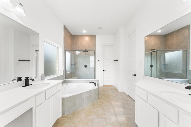 bathroom featuring a garden tub, tile patterned floors, a sink, and a shower stall