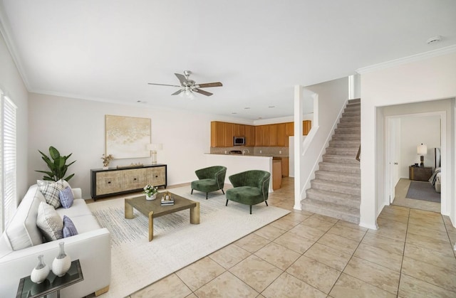 living room with ornamental molding, ceiling fan, stairway, and light tile patterned floors