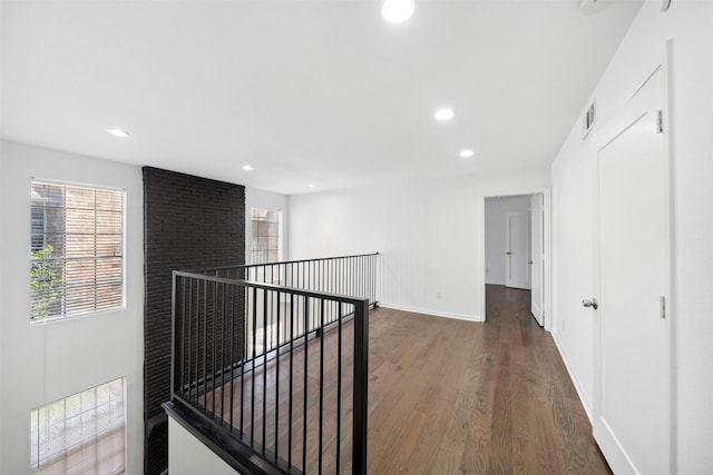 hallway with recessed lighting, visible vents, plenty of natural light, and wood finished floors