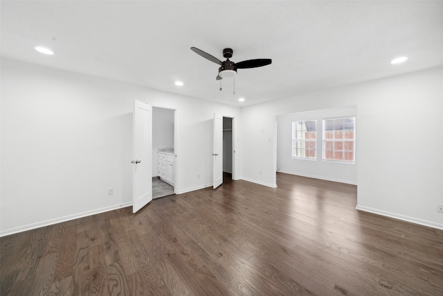 interior space with connected bathroom, recessed lighting, dark wood-style flooring, and baseboards