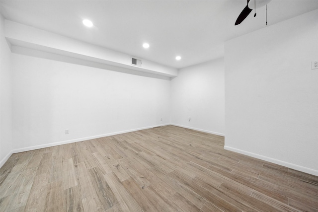 empty room with a ceiling fan, visible vents, wood finished floors, baseboards, and recessed lighting