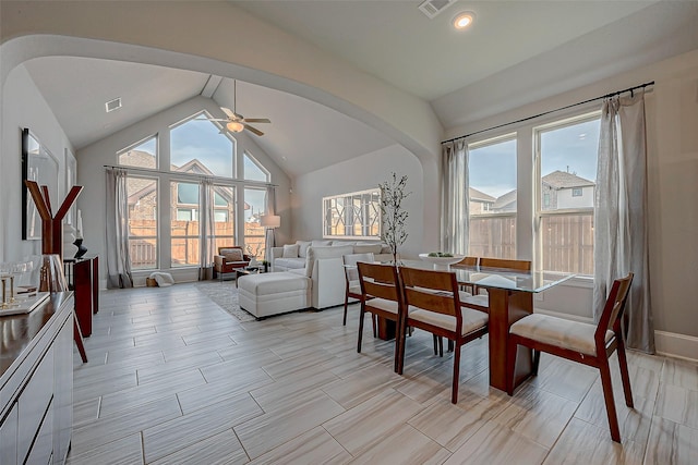 dining room with ceiling fan, vaulted ceiling, arched walkways, and visible vents