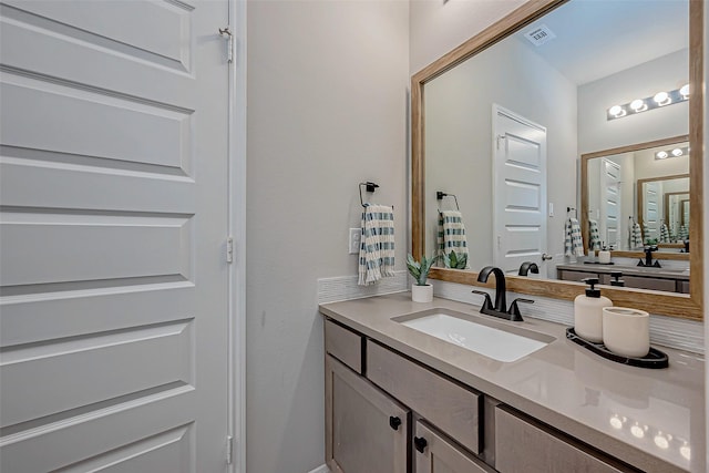 bathroom with visible vents and vanity