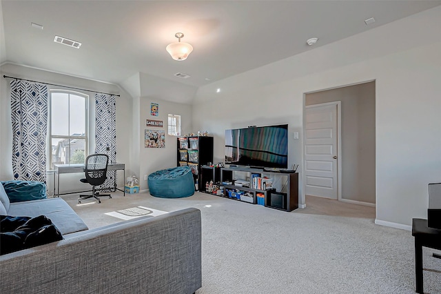 living room featuring carpet, visible vents, lofted ceiling, and baseboards