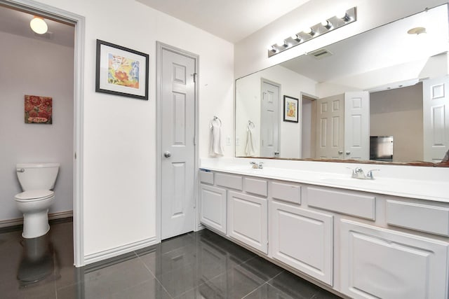 bathroom with double vanity, visible vents, toilet, tile patterned flooring, and a sink