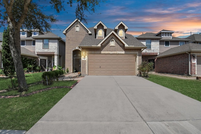 view of front facade with an attached garage, brick siding, concrete driveway, roof with shingles, and a front lawn