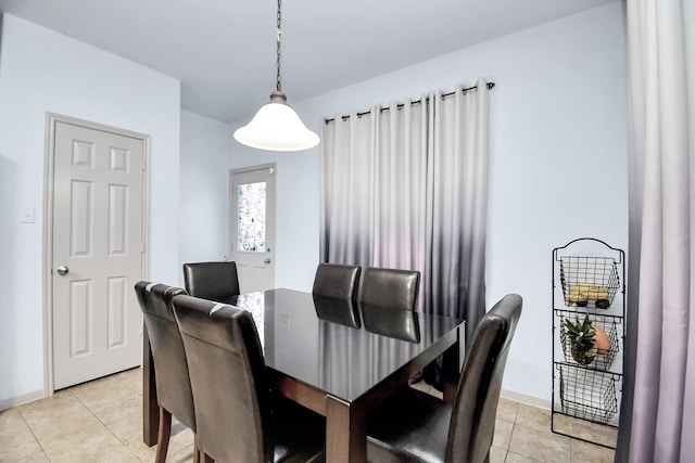 dining space with light tile patterned floors and baseboards