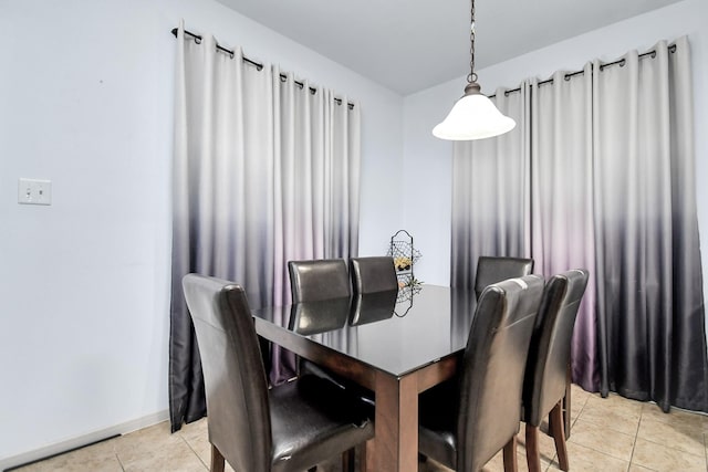 dining room featuring light tile patterned flooring and baseboards