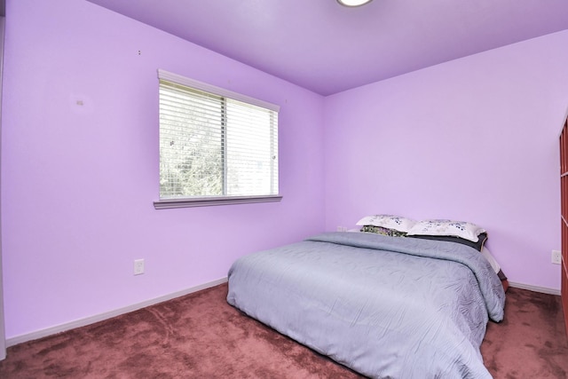 carpeted bedroom with baseboards