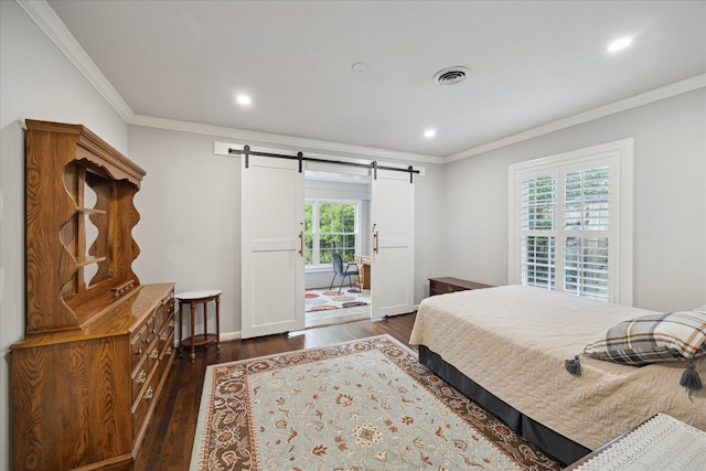 bedroom with a barn door, recessed lighting, visible vents, ornamental molding, and dark wood finished floors