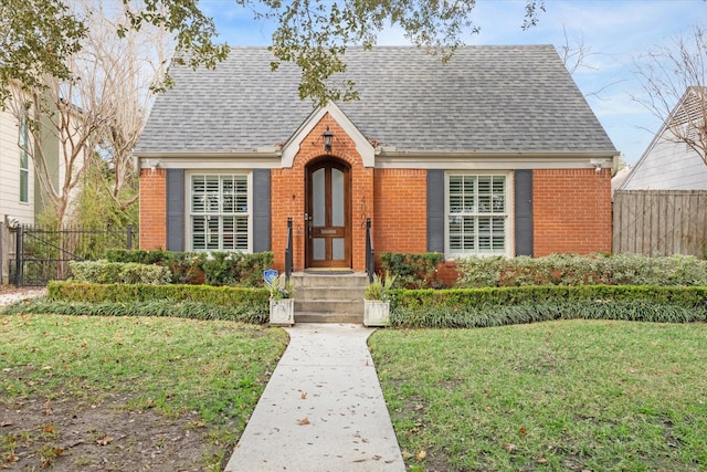 view of front facade with fence and brick siding