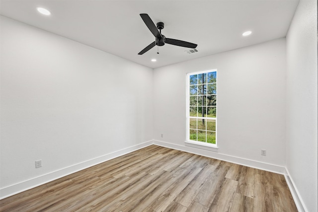 spare room featuring visible vents, baseboards, wood finished floors, and recessed lighting